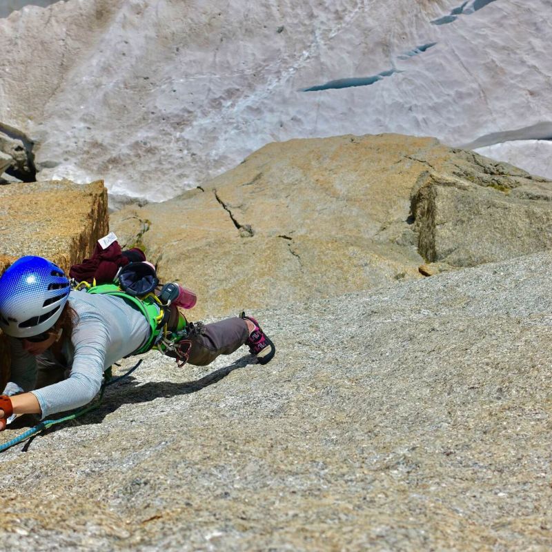 Climber on a technical pitch at Envers des Aiguilles with guide support